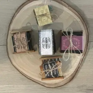 Exfoliating Moisture Bar Soaps beautifully wrapped and tied with twine, arranged on a wooden platter for a natural, elegant touch.