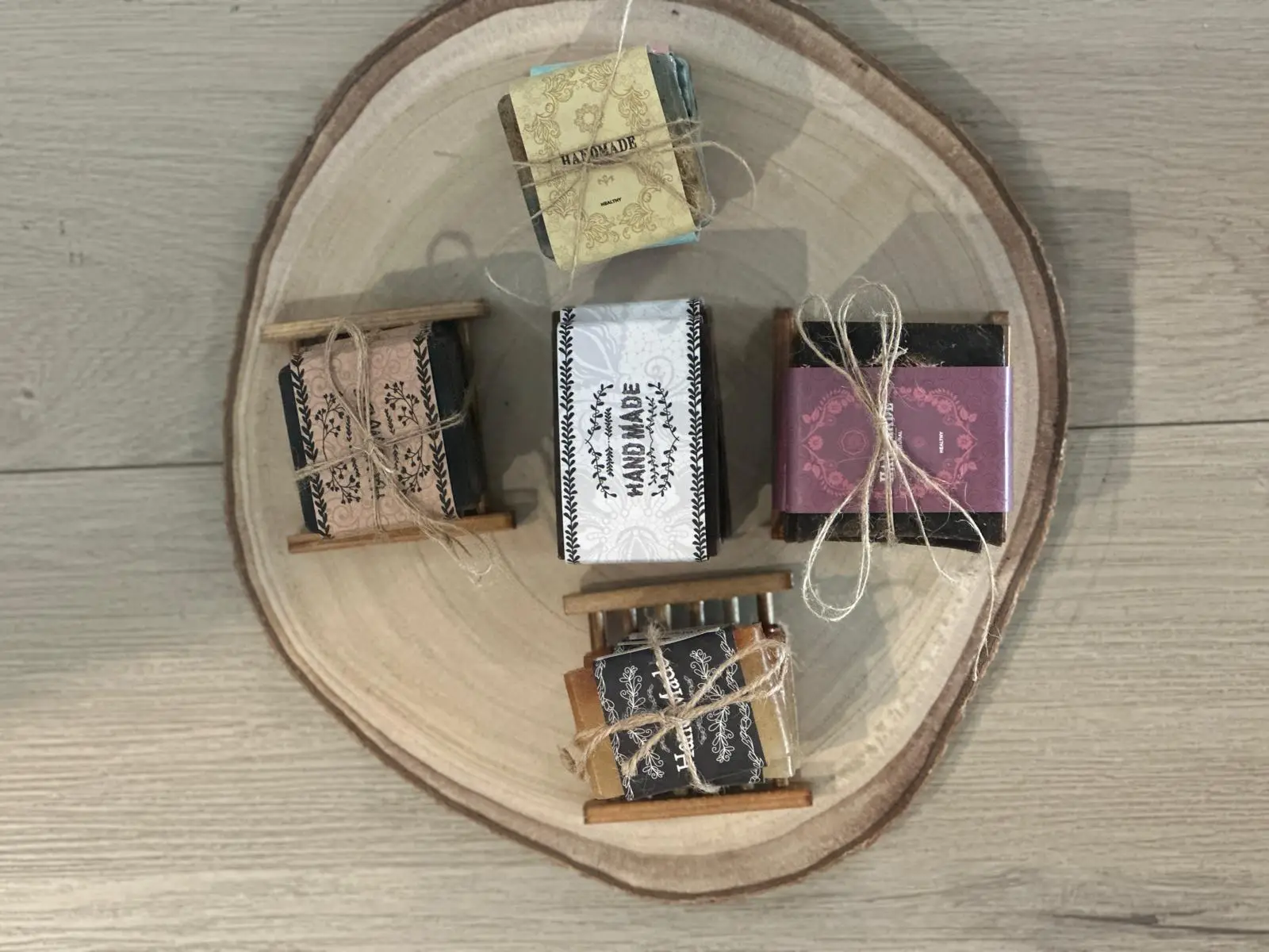 Exfoliating Moisture Bar Soaps beautifully wrapped and tied with twine, arranged on a wooden platter for a natural, elegant touch.